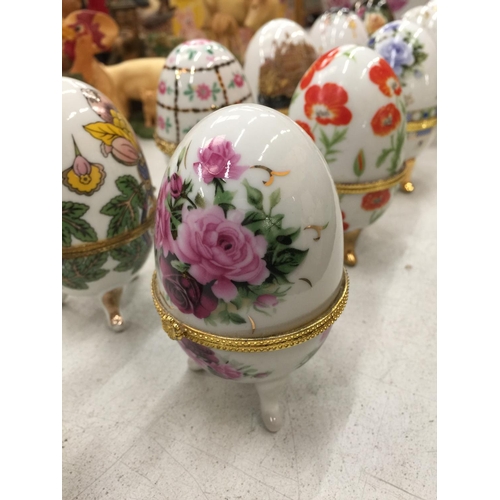 173 - ELEVEN PORCELAIN HINGED FOOTED TRINKET BOXES  IN THE SHAPE OF EGGS