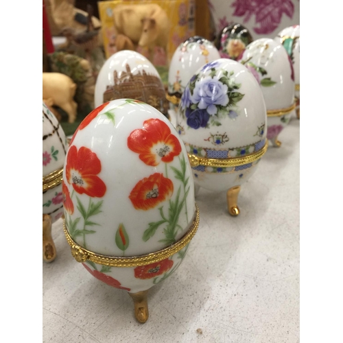 173 - ELEVEN PORCELAIN HINGED FOOTED TRINKET BOXES  IN THE SHAPE OF EGGS