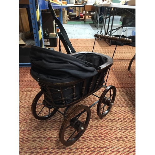 234 - A VINTAGE STYLE  WOODEN DOLL'S PRAM WITH METAL SUSPENSION, A HOOD AND BLACK FITTED INTERIOR