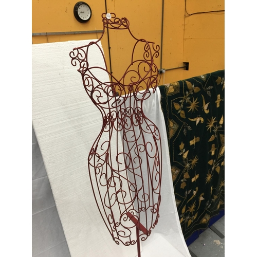 41 - A DECORATIVE METAL WIRE SILHOUETTE OF A FEMALE TORSO ON A HEAVY CAST IRON STAND