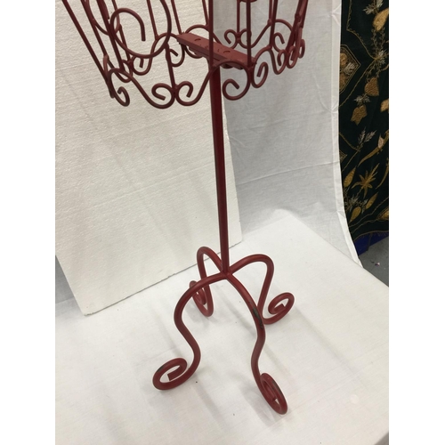 41 - A DECORATIVE METAL WIRE SILHOUETTE OF A FEMALE TORSO ON A HEAVY CAST IRON STAND