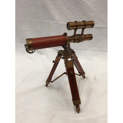 47 - A SMALL BRASS AND LEATHER TELESCOPE ON WOODEN TRIPOD STAND H: 30CM