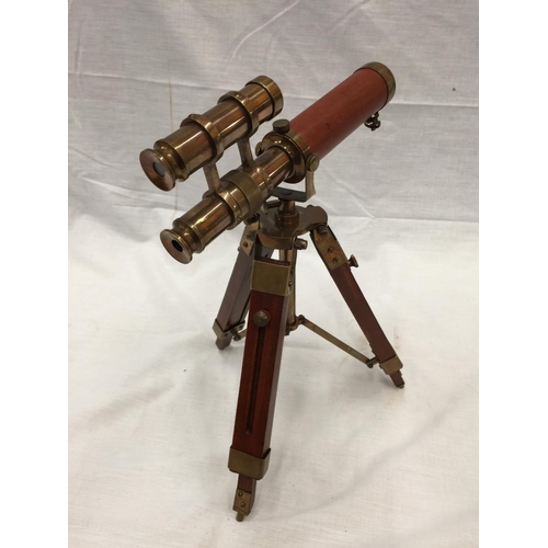 47 - A SMALL BRASS AND LEATHER TELESCOPE ON WOODEN TRIPOD STAND H: 30CM