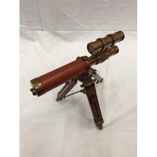 47 - A SMALL BRASS AND LEATHER TELESCOPE ON WOODEN TRIPOD STAND H: 30CM