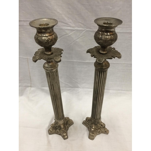 48 - A PAIR OF SILVER PLATED CANDLESTICKS WITH COLUMN DECORATION HEIGHT 45.5CM