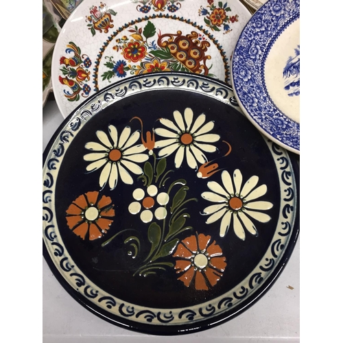 494 - A QUANTITY OF WALL HANGING PLATES PLUS LARGE SERVING PLATES