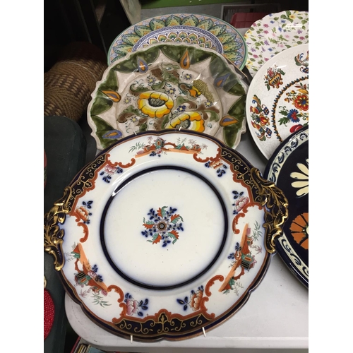 494 - A QUANTITY OF WALL HANGING PLATES PLUS LARGE SERVING PLATES