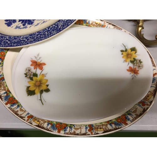 494 - A QUANTITY OF WALL HANGING PLATES PLUS LARGE SERVING PLATES