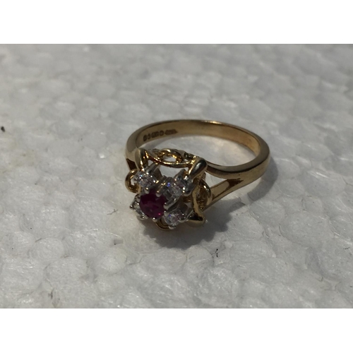 653 - A 9CT GOLD RING WITH RUBY AND CUBIC ZIRCONIA STONES