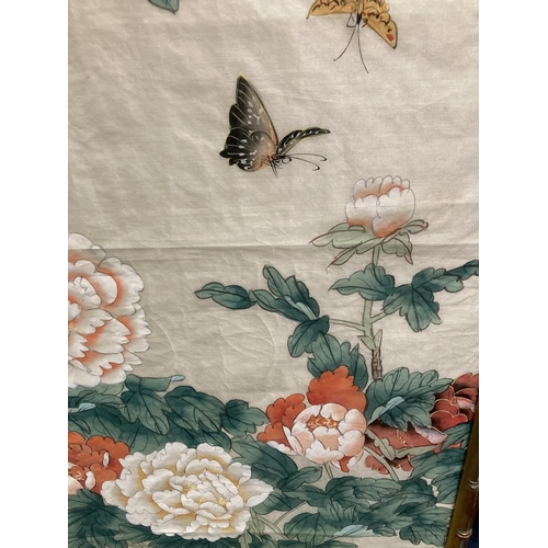 388 - AN ORIENTAL PRINT ON SILK OIN A BAMBOO FRAME 109CM X 58.5CM