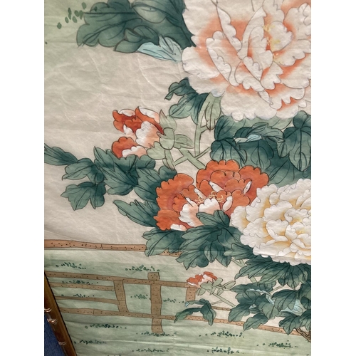 388 - AN ORIENTAL PRINT ON SILK OIN A BAMBOO FRAME 109CM X 58.5CM