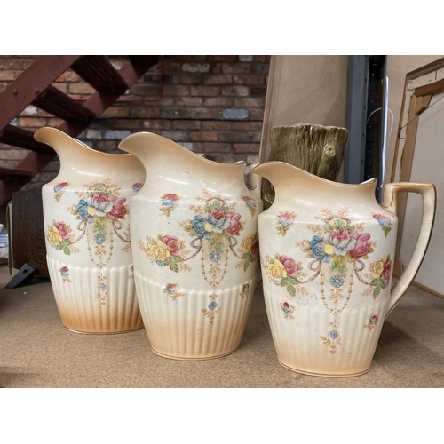 428 - THREE BLUSH IVORY JUGS BY CROWN DEVON IN GRADUATING SIZES