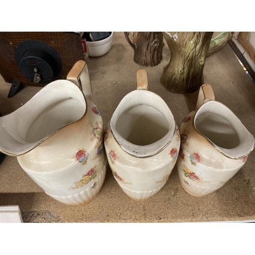 428 - THREE BLUSH IVORY JUGS BY CROWN DEVON IN GRADUATING SIZES