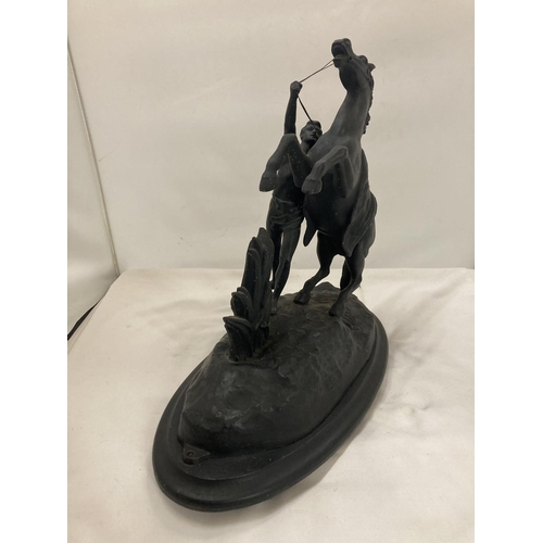 436 - A METAL FIGURE OF A BOY AND A HORSE HEIGHT 34CM, LENGTH 38CM