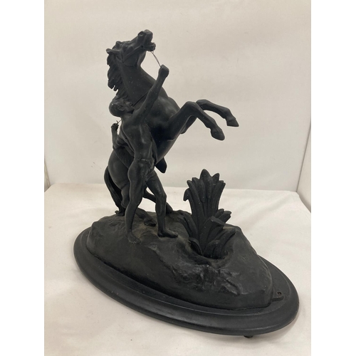 436 - A METAL FIGURE OF A BOY AND A HORSE HEIGHT 34CM, LENGTH 38CM