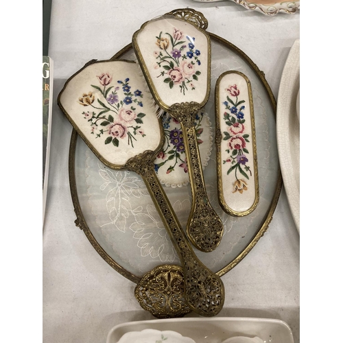 863 - A 'PETIT POINT' TRAY, BRUSHES AND MIRROR SET WITH BACK EMBROIDERY PLUS THREE DRESSING TABLE SETS