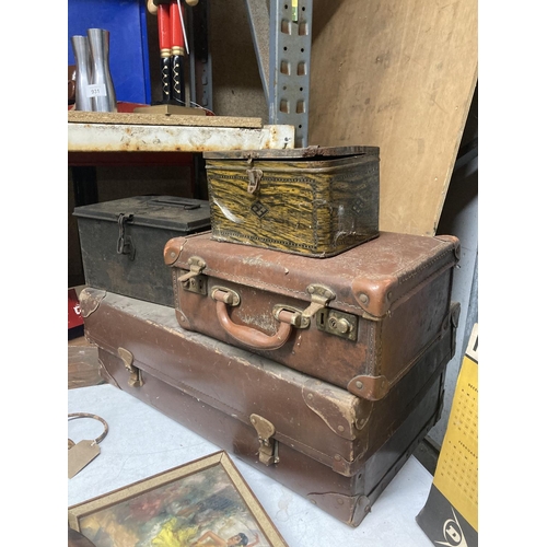 910 - A LARGE AND SMALL VINTAGE LEATHER SUITCASE PLUS TWO VINTAGE TINS