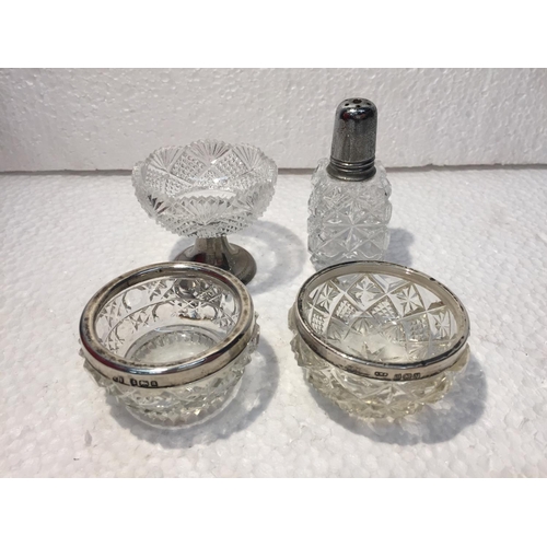 687 - TWO CUT GLASS HALLMARKED BIRMINGHAM SILVER RIMMED SALTS PLUS A CUT GLASS MUSTARD DISH AND CRUET WITH... 