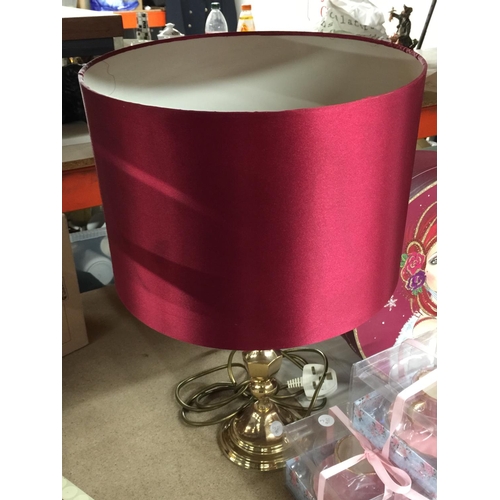 922 - A BRASS TABLE LAMP WITH A BURGUNDY LAMP SHADE, DECORATIVE BOX BOXED CANDLES IN CUPS, ETC