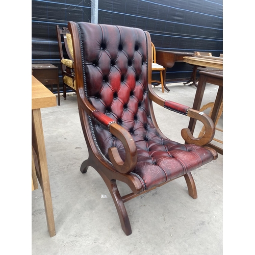 2682 - AN OXBLOOD X-FRAMED FIRESIDE CHAIR