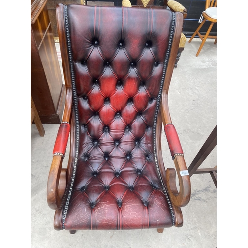 2682 - AN OXBLOOD X-FRAMED FIRESIDE CHAIR