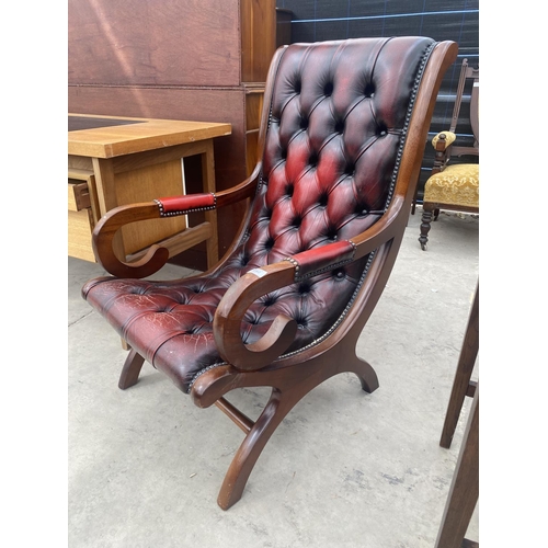 2682 - AN OXBLOOD X-FRAMED FIRESIDE CHAIR