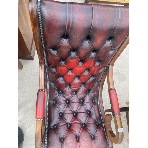 2682 - AN OXBLOOD X-FRAMED FIRESIDE CHAIR