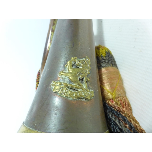 395 - A COPPER AND BRASS BUGLE WITH BADGE, LENGTH 28CM