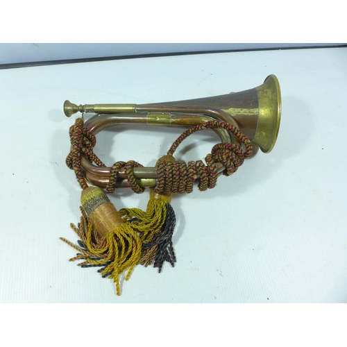 395 - A COPPER AND BRASS BUGLE WITH BADGE, LENGTH 28CM