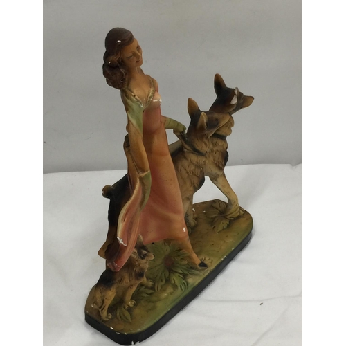 44 - AN EARLY 20TH CENTURY ART DECO STYLE CHALKWARE FIGURE OF A LADY AND TWO GERMAN SHEPHERDS MARKED RD 8... 