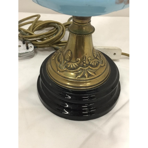 50 - A CONVERTED VINTAGE BRASS OIL LAMP ON BRASS STAND AND SOLID HEAVY BASE WITH PAINTED CERAMIC DECORATI... 