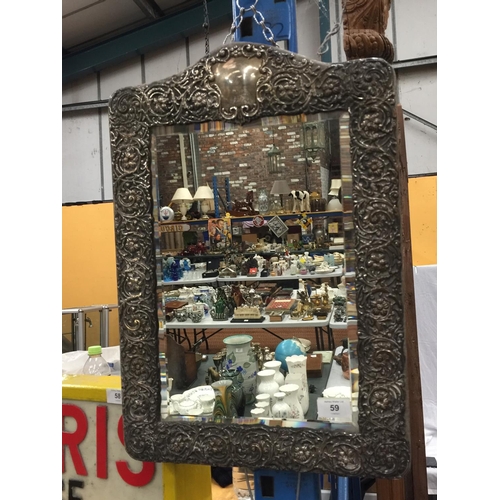 59 - AN ORNATELY DECORATED WALL HANGING MIRROR WITH POSSIBLY SILVER FRAME H: 52CM