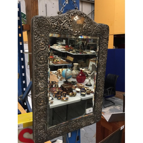 59 - AN ORNATELY DECORATED WALL HANGING MIRROR WITH POSSIBLY SILVER FRAME H: 52CM