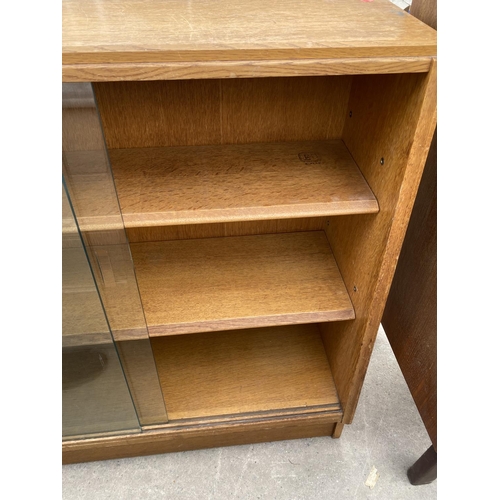 2650 - A G-PLAN E.GOMME BOOKCASE WITH SLANTING FRONT, HAVING TWO GLASS SLIDING DOORS, 36