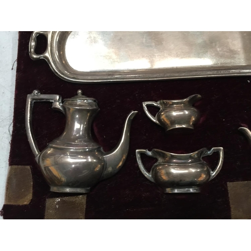 23 - A SET OF BIRMINGHAM HALLMARKED SILVER MINIATURE TEAPOTS AND JUGS IN A CASE