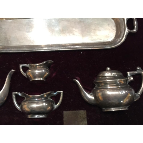 23 - A SET OF BIRMINGHAM HALLMARKED SILVER MINIATURE TEAPOTS AND JUGS IN A CASE