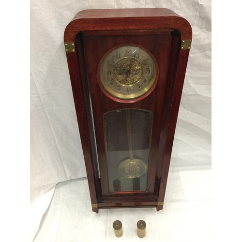 24 - AN ART NOUVEAU STYLE MAHOGANY CASED WALL CLOCK WITH BRASS AND SILVERED DIAL