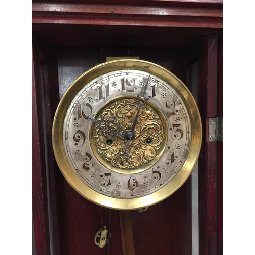 24 - AN ART NOUVEAU STYLE MAHOGANY CASED WALL CLOCK WITH BRASS AND SILVERED DIAL