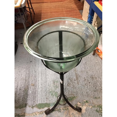 38 - A LARGE BELL SHAPED GLASS BOWL ON A WROUGHT IRON STAND H: 96CM