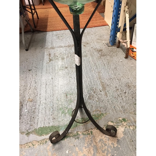 38 - A LARGE BELL SHAPED GLASS BOWL ON A WROUGHT IRON STAND H: 96CM