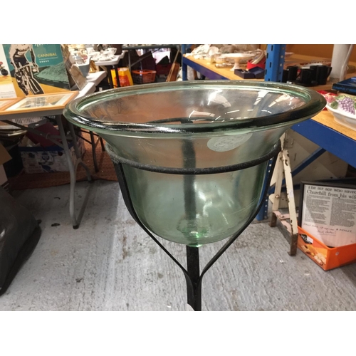 38 - A LARGE BELL SHAPED GLASS BOWL ON A WROUGHT IRON STAND H: 96CM