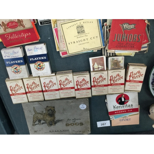 207 - A QUANTITY OF CIGARETTE CARDS INCLUDING AN ALBUM OF DOGS, VINTAGE CIGARETTE PACKS AND CIGARETTE PACK... 