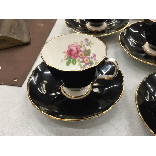 215 - TWO VINTAGE PART TEASETS TO INCLUDE ADDERLEY FLORAL BLACK CUPS AND SAUCERS PLUS ART DECO STYLE ORANG... 