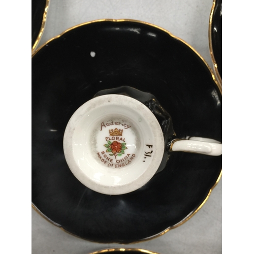 215 - TWO VINTAGE PART TEASETS TO INCLUDE ADDERLEY FLORAL BLACK CUPS AND SAUCERS PLUS ART DECO STYLE ORANG... 