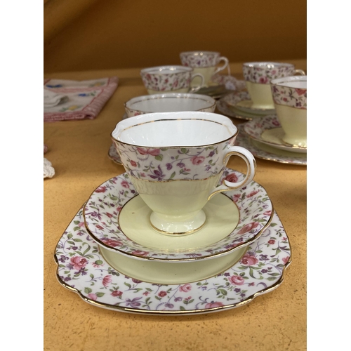 261 - A WINDSOR CHINA TEASET IN A YELLOW AND FLORAL PATTERN WITH GILT RIMS TO INCLUDE A CAKE PLATE, CREAM ... 