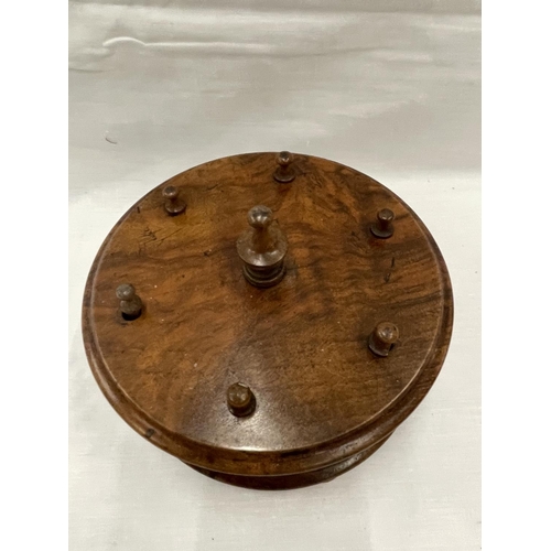 6A - A 19TH CENTURY WALNUT BOBBIN HOLDER ON THREE FEET WITH A TURNED FINIALE TO HOLD SIX BOBBINS