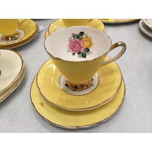 192 - SIX BONE CHINA TRIOS WITH ROSE DECORATION AND GILDING TO THE RIMS AND HANDLES