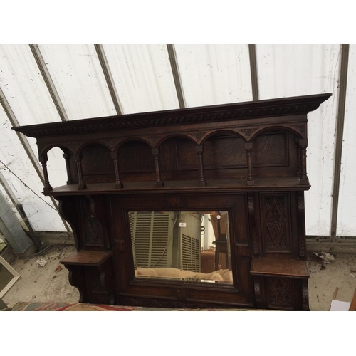 2561 - A HEAVILY CARVED OAK OVERMANTEL MIRROR