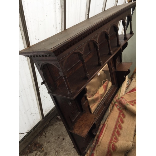 2561 - A HEAVILY CARVED OAK OVERMANTEL MIRROR