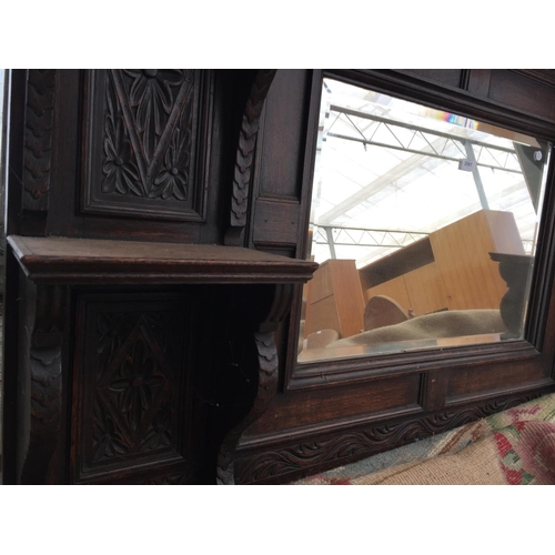 2561 - A HEAVILY CARVED OAK OVERMANTEL MIRROR